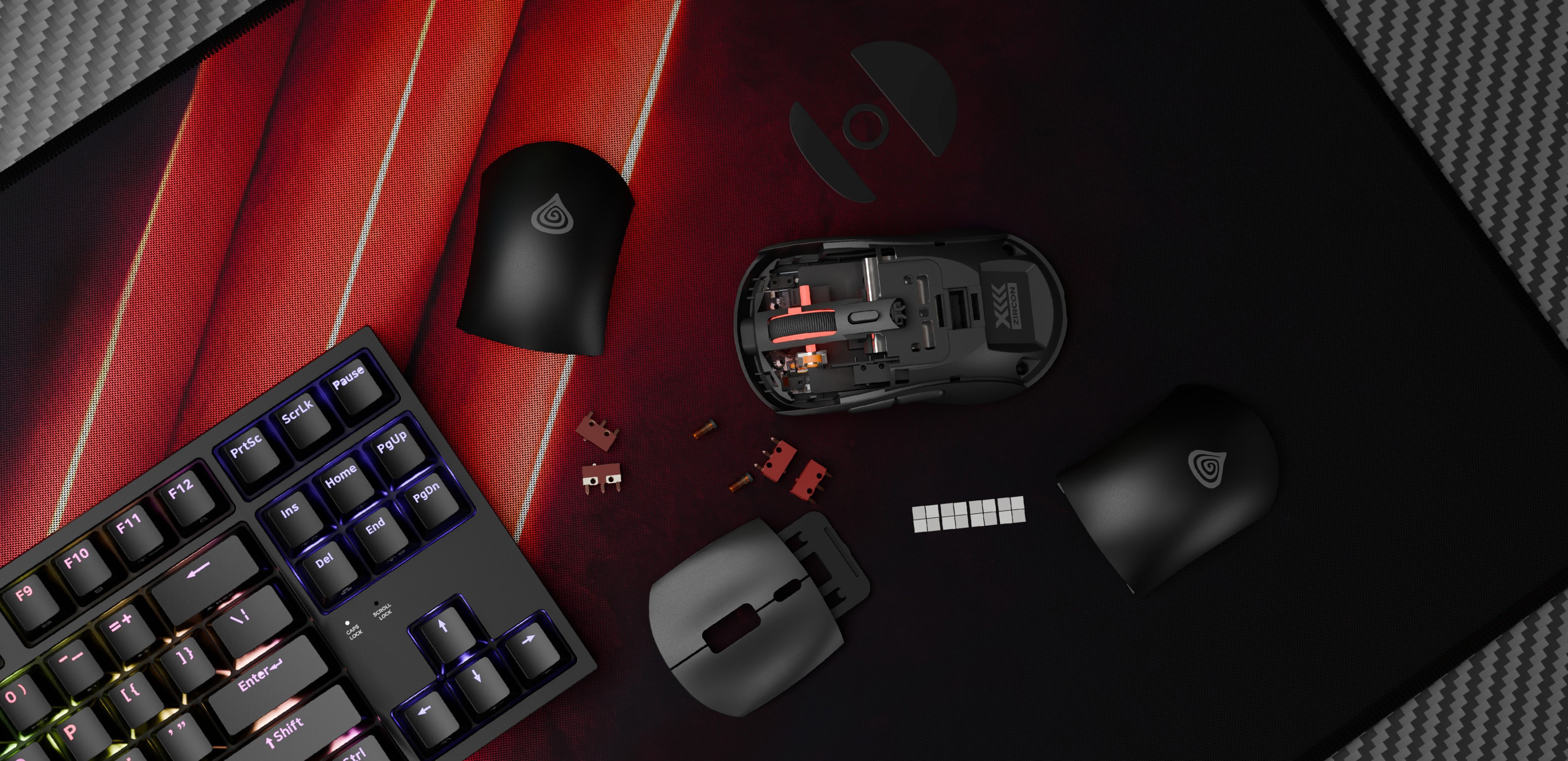 Souris de jeu sans fil Genesis Zircon XIII en noir, avec des caches amovibles et des composants sur un tapis de souris texturé aux côtés d'un clavier.