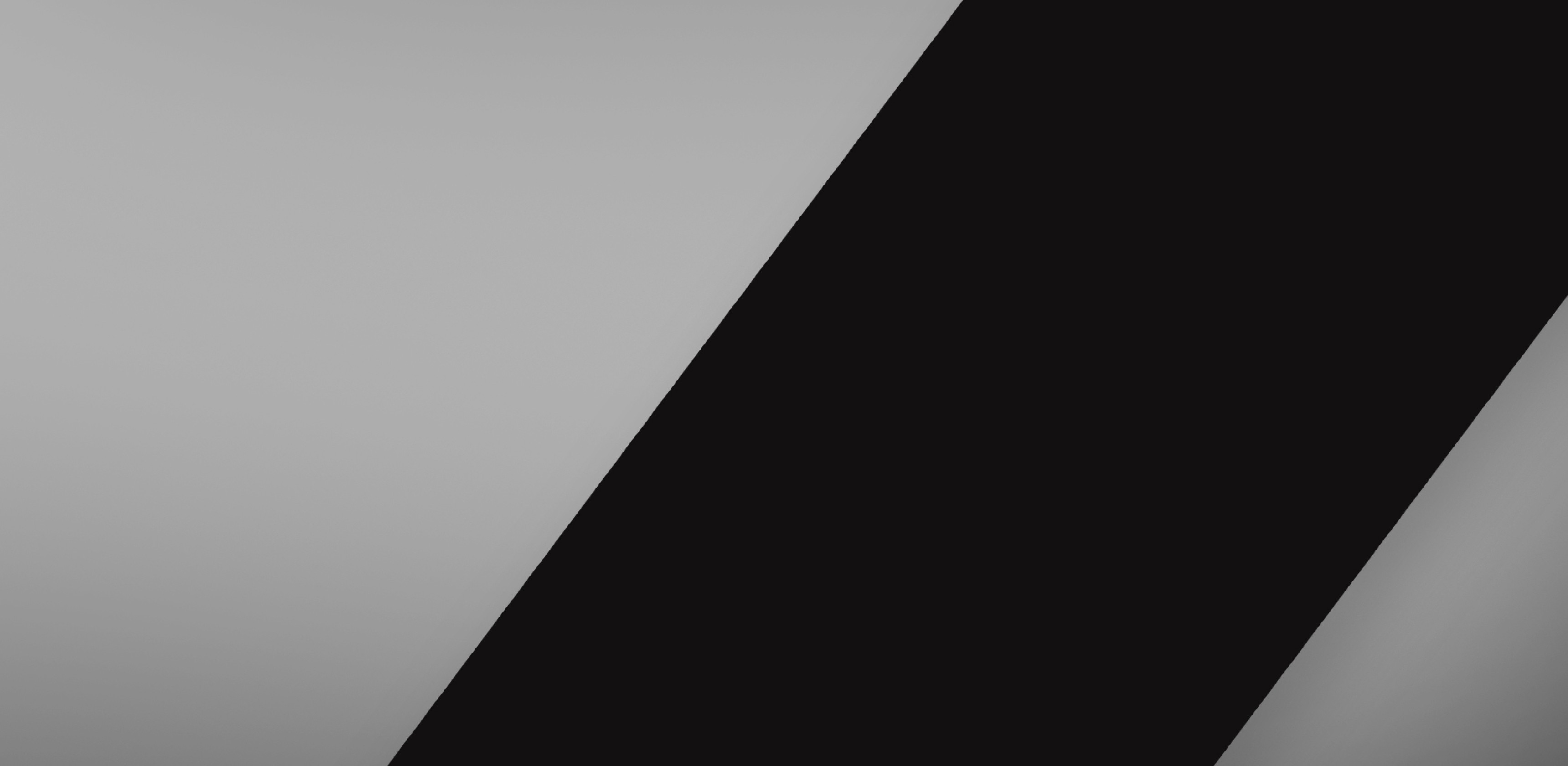 Surface de bureau présentant des motifs diagonaux gris et noirs lisses, conçue pour les jeux.